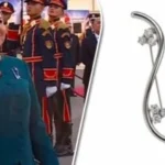بروش السيدة انتصار السيسي في استقبال الرئيس الصيني وقرينته يرمز للسلام